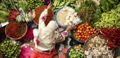 muslim woman selling fresh vegetables at market in kota baru malaysia