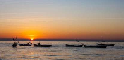 Boats on the Irrawaddy River at sunset