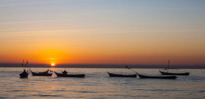 Boats on the Irrawaddy River at sunset