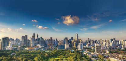 Stunning cityscape at sunset in Bangkok with green park and skyline