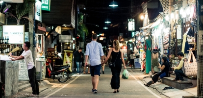 Couples walking through Asia market