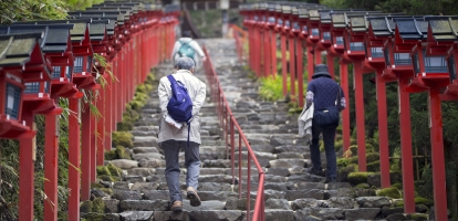 Two people walking up steps to Kifune Shrine