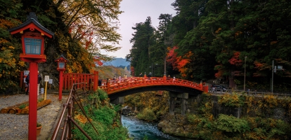 Ornate red bridge over river in Nikko