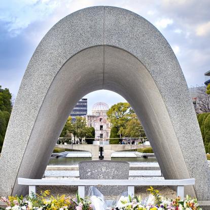 Stone arch with flowers in front at the peace memorial in Hiroshima
