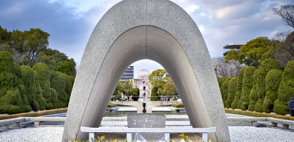 Stone arch with flowers in front at the peace memorial in Hiroshima