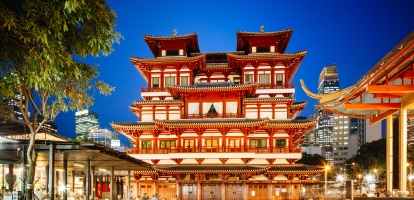 Ornate red temple in middle of square in Chinatown, Singapore