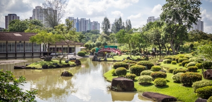 Red bridge over ornamental lake in Chinese and Japanese Gardens in Singapore