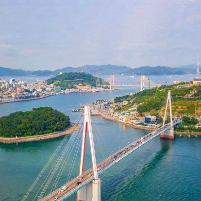 Beautiful aerial shot of Dolsan bridge in Yeosu bay, with tranquil ocean waters and green islands