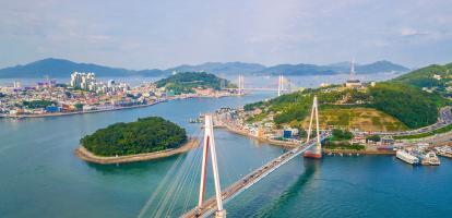 Beautiful aerial shot of Dolsan bridge in Yeosu bay, with tranquil ocean waters and green islands