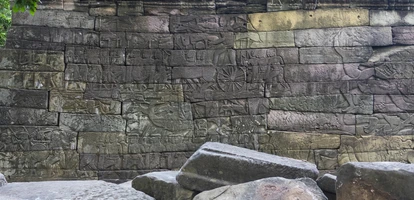 Stone wall with carvings in the ruins of Banteay Chhmar in Cambodia