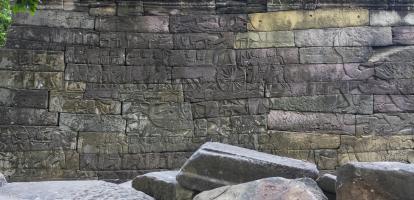 Stone wall with carvings in the ruins of Banteay Chhmar in Cambodia