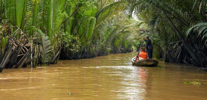 Tourists on boat along the river in the Mekong Delta area in Vietnam
