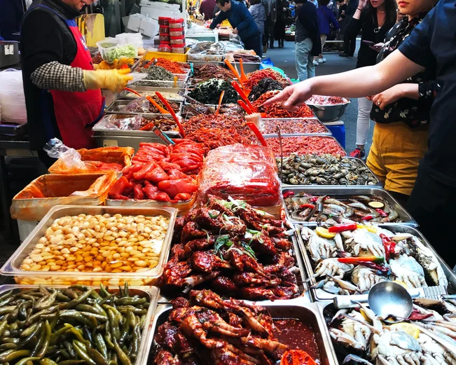 Customers selecting spices at a food market in Seoul 