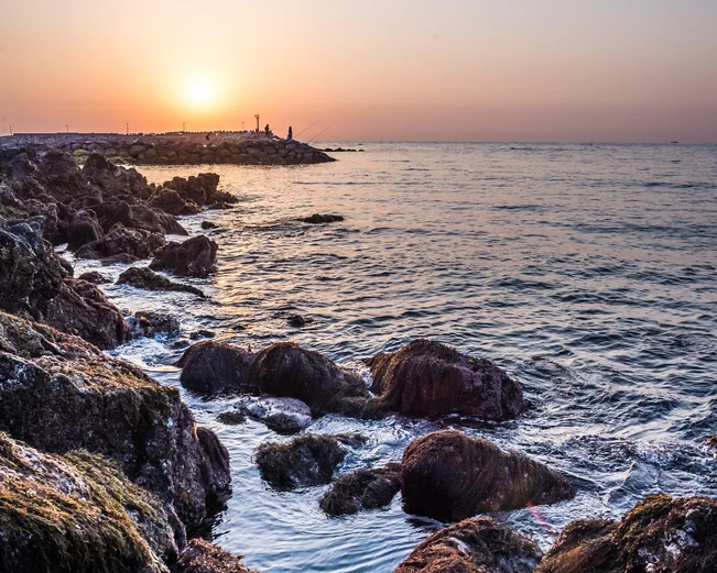 Sunrise over rocky pier in Jeju Island