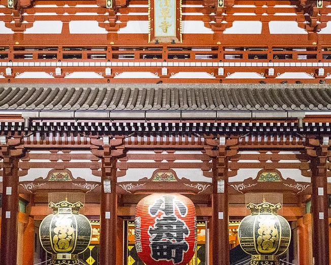 Person walking past red gates at Asakusa Temple, Tokyo 
