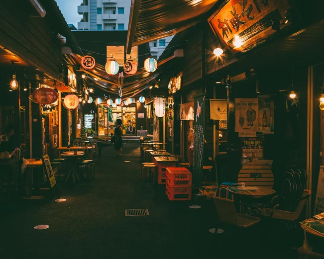 Japanese food stalls and outdoor seating at night 