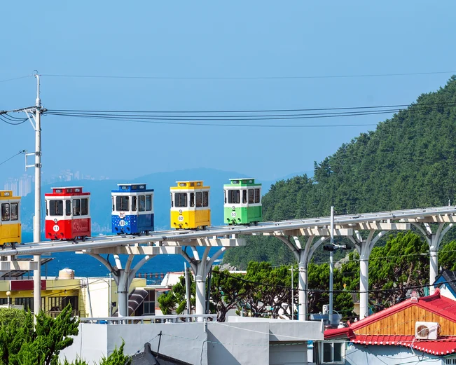 Cute and colorful little trams are lined up in Haundae's Blue Park in Busan, South Korea
