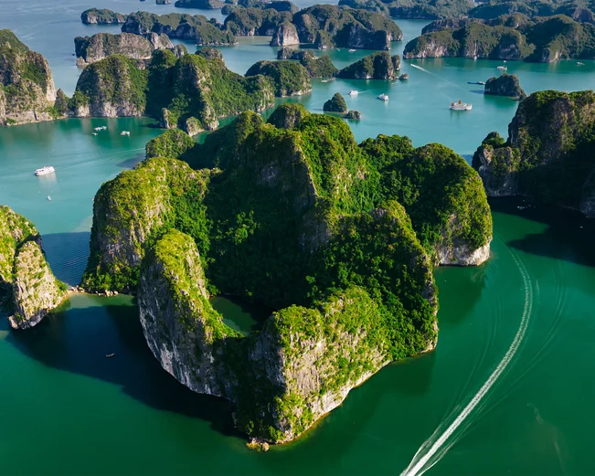 Aerial shot of the fascinating karst rock formations in Lan Ha Bay, with cruise ships in view