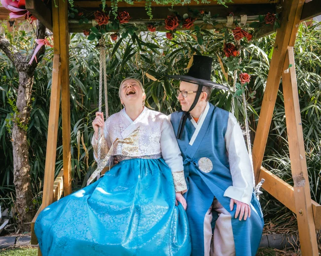 A couple of tourists dressed in traditional South Korean hanbok during a photoshoot 