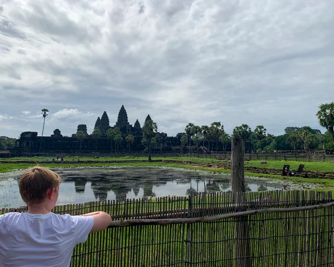 A young boy looking at Angkor Wat temple on a family trip to Cambodia