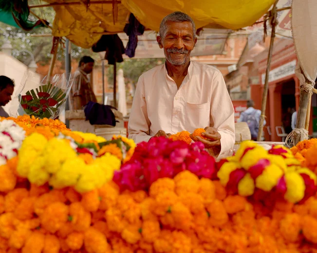 A friendly man in Jaipur at a marigold store in October