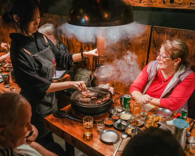 People eating at a Korean BBQ restaurant