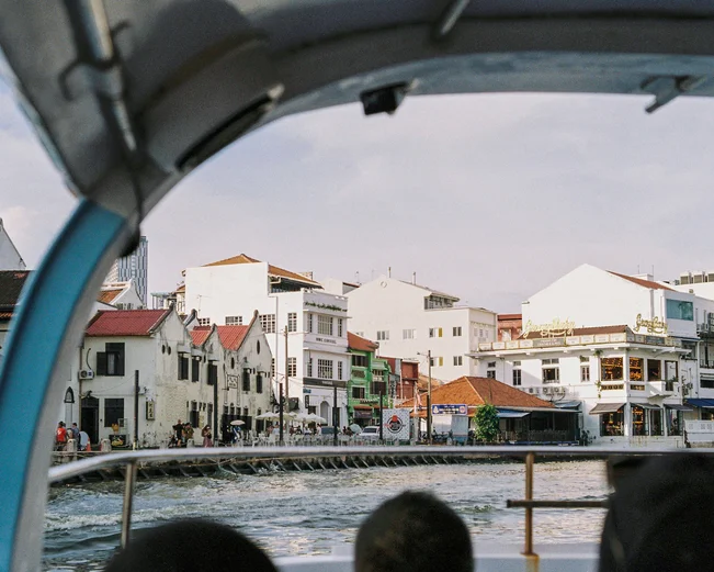 A view of the Malacca River and buildings alongside, taken from onboard a sightseeing passenger boat