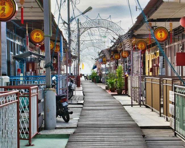 clan jetty with a wooden walkway and houses alongside