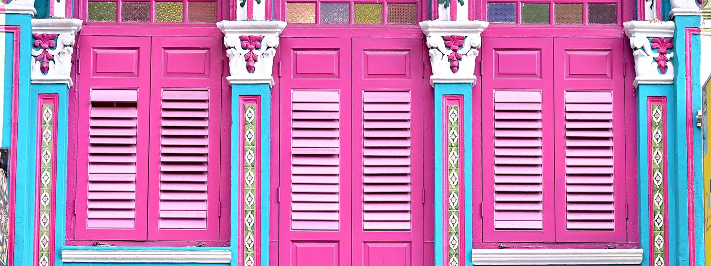 Bright pink doors and colourful trim on Peranakan building in Singapore 