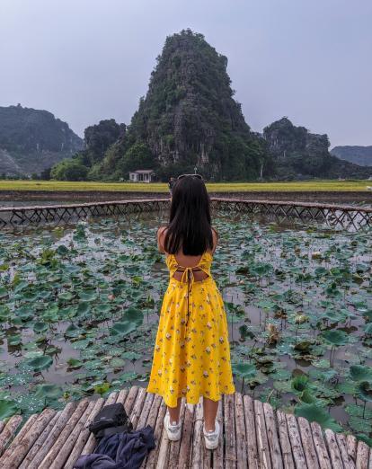 Girl in yellow dress taking photograph in Ninh Binh
