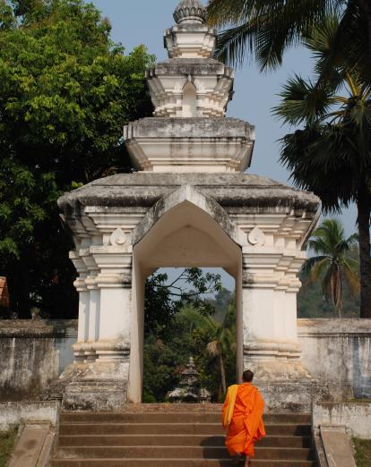 Monk walking up steps in Luang Prabang
