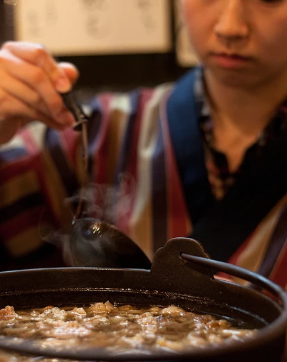 Lady eating Japanese food with chopsticks 