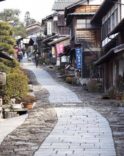 Cobbled street past traditional wooden houses on the Nakasendo Way