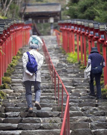 Two people climbing steps to Kifune Shrine