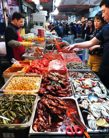 Customers selecting spices at a food market in Seoul
