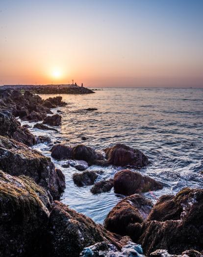 Sunrise over rocky pier in Jeju Island