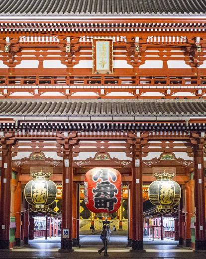 Person walking past red gates at Asakusa Temple, Tokyo