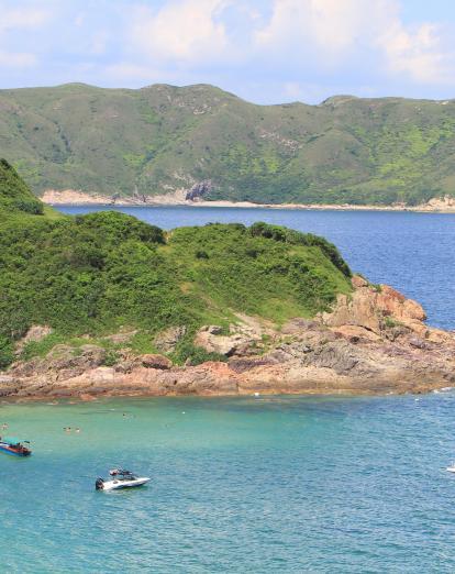 Boats anchored up by secluded island in Sai Kung Country Park