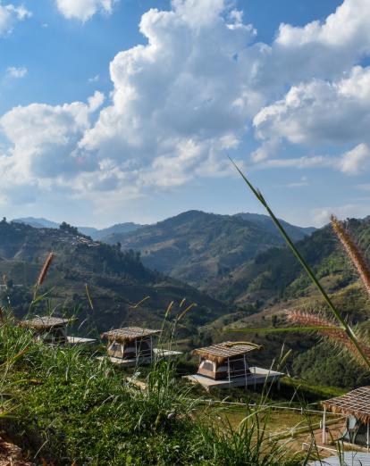 Northern Thailand countryside with trees and huts