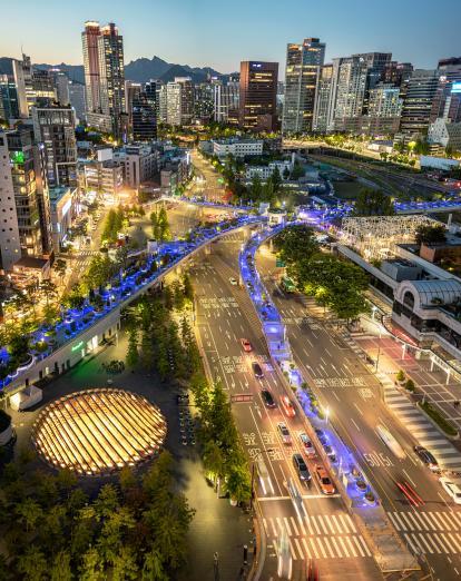 Warm lights shine from urban Seoul at dusk in South Korea