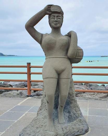 Stone statue of a female diver in Jeju Island South Korea