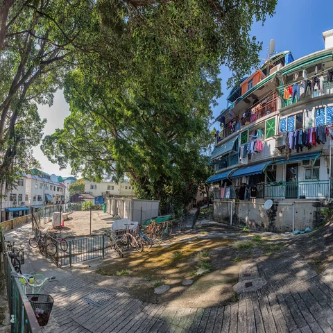 Colourful buildings with washing hanging and bicycle propped up outside 