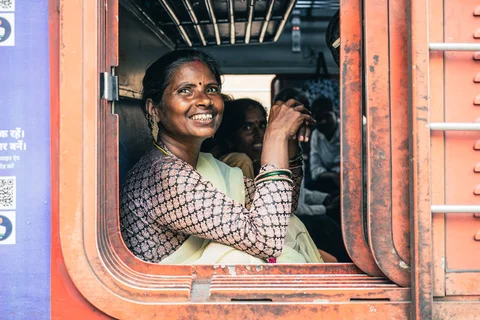 Indian woman smiling from a train