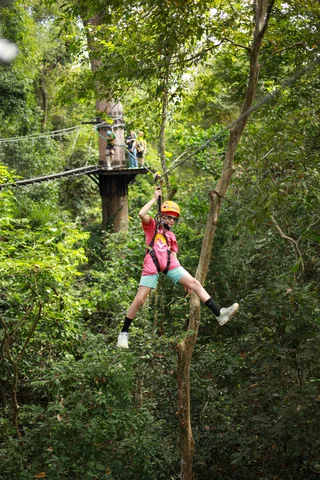 A young boy on a zipline in Angkor during a family adventure in Siem Reap, Cambodia