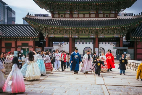 Seoul palace in November with people wearing traditional hanbok 