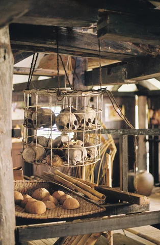 Skulls in a cage of the kuching tribe in Borneo staying in a longhouse in the jungle