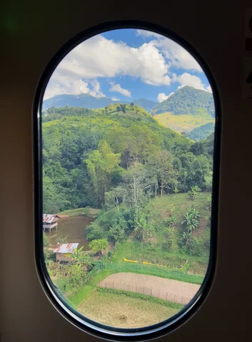 A view from a train window of Laos countryside on a Laos by Rail itinerary