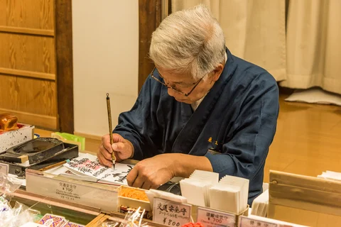 Nara man writing traditional caligraphy Japan