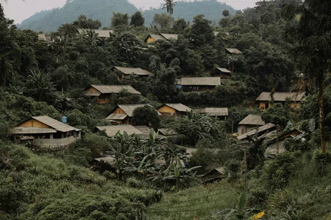 A village built into the hillside surrounded by greenery