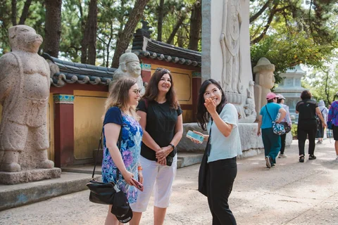 guide and two customers outside haedong yonggunsa temple